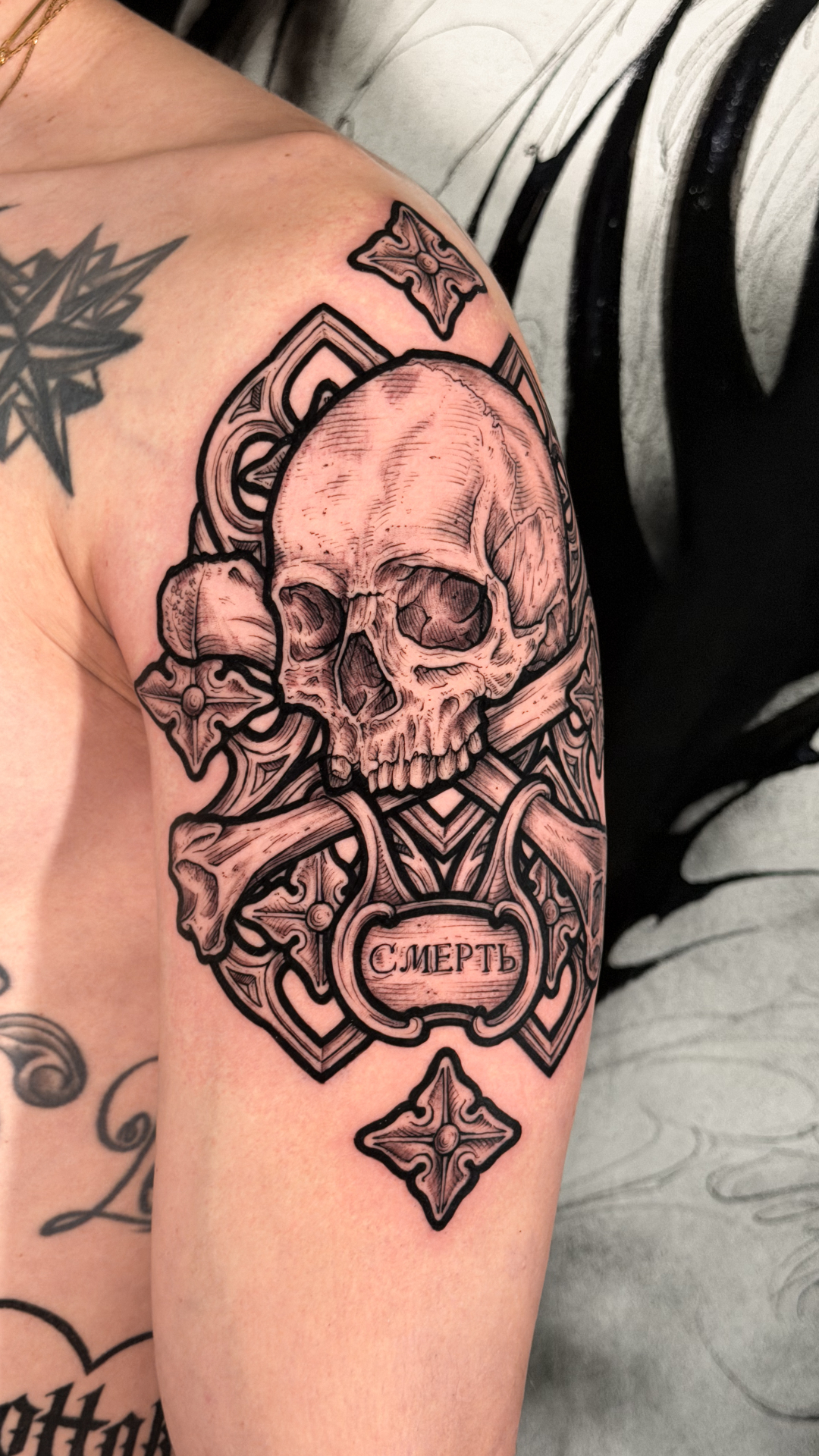 Skull and orthodox cross shoulder tattoo in engraving style